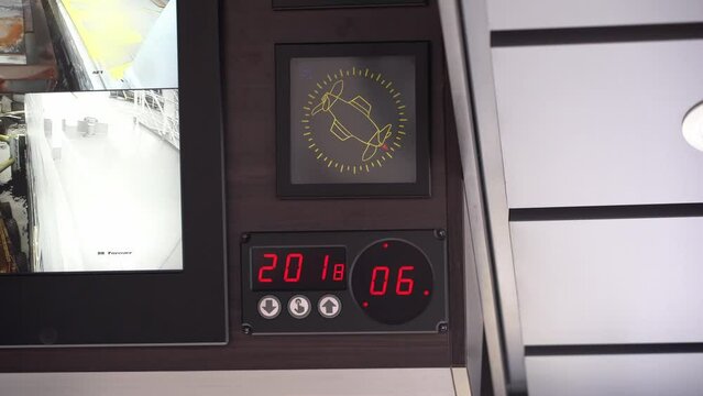 Ships thrusters rotating and pushing ship out from dock - Low angle looking up towards thruster display and gyro compass changing heading while departing