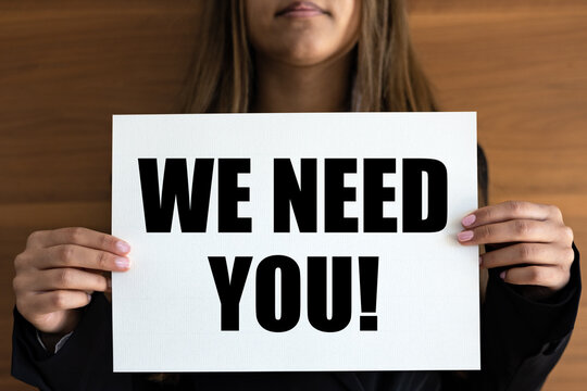 We need you. Woman holds a white page with orange text.  Recruitment, searching, job opprtunity, hiring, team, employment and labour.