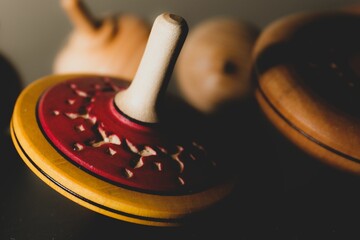 Closeup of colorful Japanese vintage wooden spinning top toys blurred background