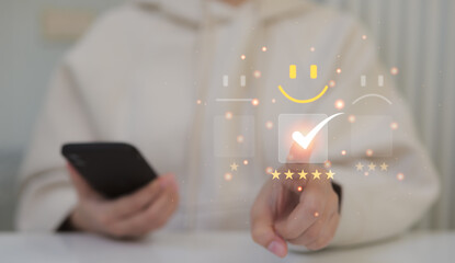 Customer service evaluation concept, Woman choosing on the happy smiley face emoticon satisfaction...