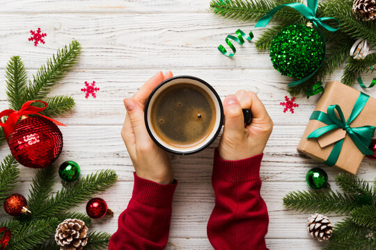 Woman holding cup of coffee. Woman hands holding a mug with hot coffee. Winter and Christmas time concept