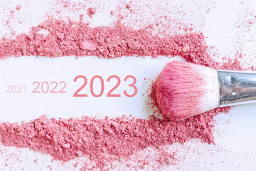 Flat lay of smear of crushed pink blush on as sample of cosmetics product with 2021 2022 2023...