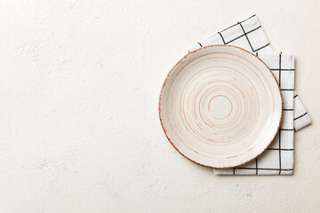 Top view on colored background empty round white plate on tablecloth for food. Empty dish on napkin with space for your design