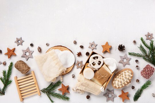 Christmas gift box with plastic free cosmetics products on white natural background, top view, copy space.