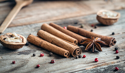 Composition with star anise and cinnamon sticks on a wooden background.