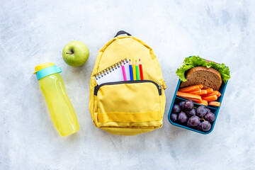 School lunch box with sandwich, fruits and water