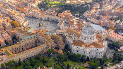 Aerial view of Papal Basilica of Saint Peter in the Vatican located in Rome, Italy. It's the most important and largest church in the world and residence of the Pope. Around it are the Vatican gardens - obrazy, fototapety, plakaty