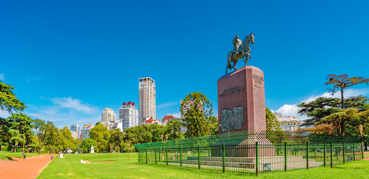 Panoramic cityscape view over green city park with exotic trees and monument of Juan Manuel de Rosas in Palermo district of Buenos Aires, Argentina