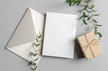 Blank greeting card mockup with gift and envelope