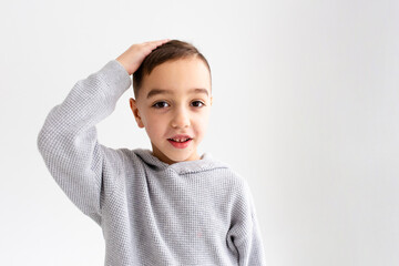  Boy child preschooler smiling and posing on gray background in photo studio