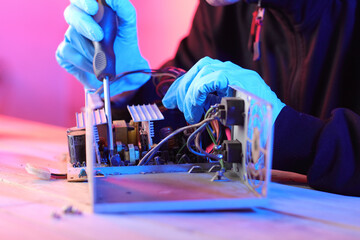 disassembly of a computer power supply on a table by a person