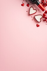 Valentine's Day concept. Top view vertical photo of wine bottle heart shaped candles red hearts and confetti on isolated pastel pink background with empty space