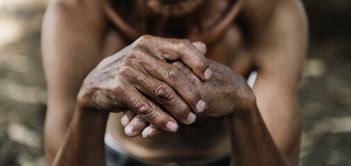 Close up of male wrinkled hands, old man is wearing