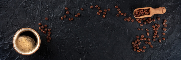 Coffee cup and beans panorama, overhead flat lay shot on a black background with copy space, a panoramic banner for a menu