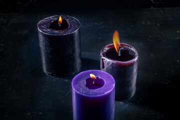 Burning candles on a dark background, mysterious ritual