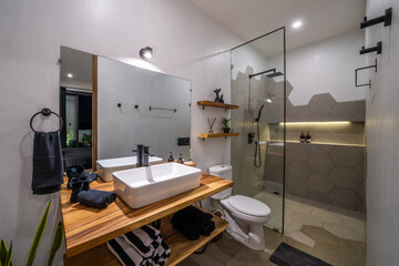 New modern white bathroom. White towels on wooden shelves