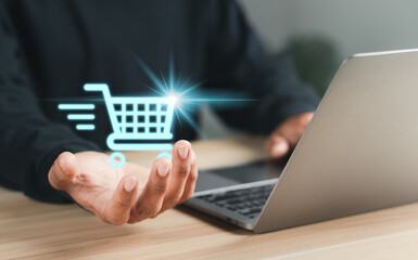 Online shopping concept. Businessman with shopping cart for online shopping on virtual screen.