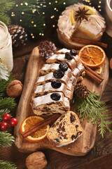 Sliced stollen cake on wooden board for Christmas top view