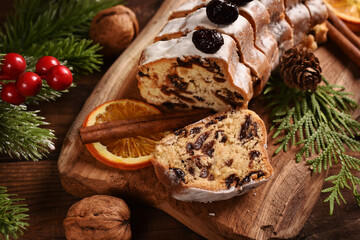 Closeup of sliced stollen cake on wooden board for Christmas