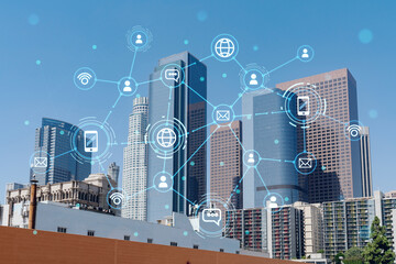 Panorama cityscape of Los Angeles downtown at day time, California, USA. Skyscrapers of LA city. Glowing Social media icons. The concept of networking and establishing new connections between people