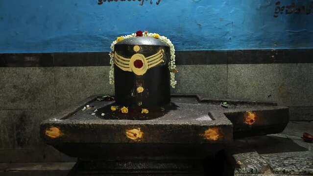 Closeup of historical black lingam or shiv ling inside temple