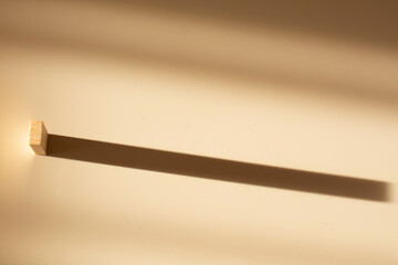 shadows from wooden blocks on a beige background. Abstract. The concept of sustainability and leadership