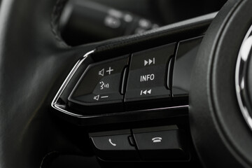 Multiple buttons on the steering wheel to accept or reject calls from the phone close up view. Answer and reject phone buttons.