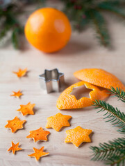 Zero waste handmade Christmas decor  - a craft made by cutting in star shape the scrap orange peel. Once they dry can be used as ornaments to decorate a Christmas tree.