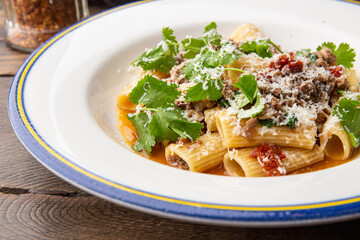Pasta bolognese with sun-dried tomatoes and parmesan