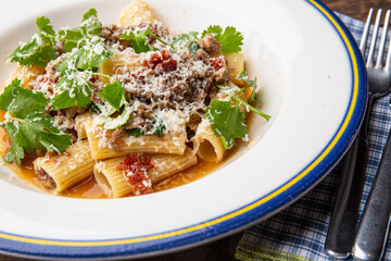 Pasta bolognese with sun-dried tomatoes and parmesan