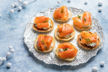 Blini with smoked salmon and sour cream, garnished with dill