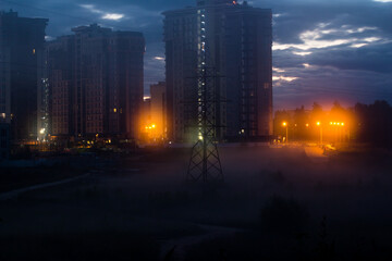Fog on a wasteland outside the city at night, urban landscape