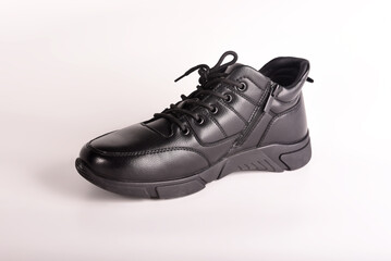 Black winter boot with black laces on a white background