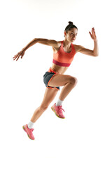Fototapeta na wymiar Athlete in motion. Young fitness sportive girl in sports uniform running, training isolated over white background. Dynamic movements, running technique.