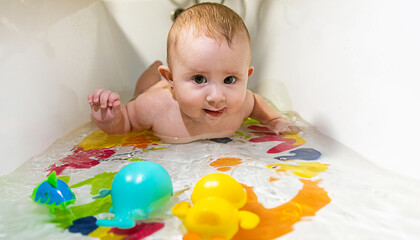 baby bathes in the bath. selective focus.