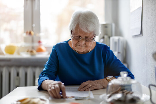 Senior woman filling out financial statements
