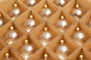 Trendy Christmas background. Transparent glass Christmas balls in box ready for holiday compositions. Christmas market store