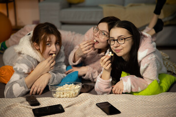 Three Cute Young Girls Under 20 In Colorful Funny Pajamas Have Fun While In Girls' Pajamas