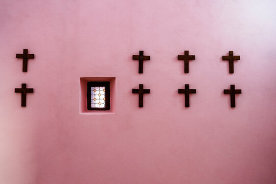 Crosses and window on pink wall