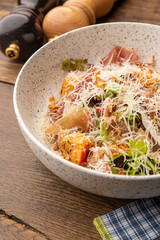 Salad with baked pumpkin, jamon and herbs