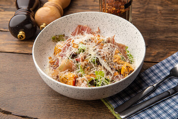 Salad with baked pumpkin, jamon and herbs