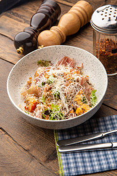 Salad with baked pumpkin, jamon and herbs
