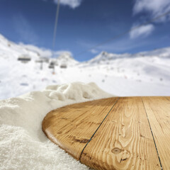 Wooden desk cover of snow flakes and winter landscape of free space. 