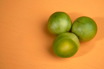Portion of umbu, or Brazil plum, over orange background