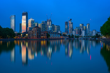 London cityscape Canary Wharf with reflection from Greenland Dock in England at twilight