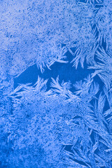 Frozen texture. Frost patterns on frozen window as a symbol of Christmas wonder.