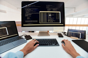 First person view of female software developer coding on computer