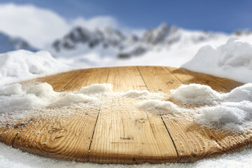 Wooden desk cover of snow flakes and winter landscape of free space. 