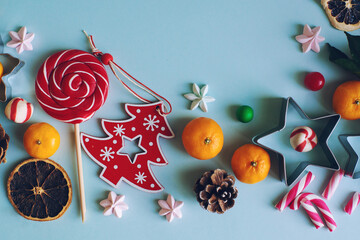 Christmas or New Year composition with candy cane, fir branch and tangerines
