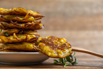 Hanukkah Potato Latkes or Potato Fritters on wooden background.